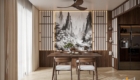 Phòng ăn sang trọng với bàn ghế gỗ óc chó đặt trước tranh phong cảnh thủy mặc và vách ngăn